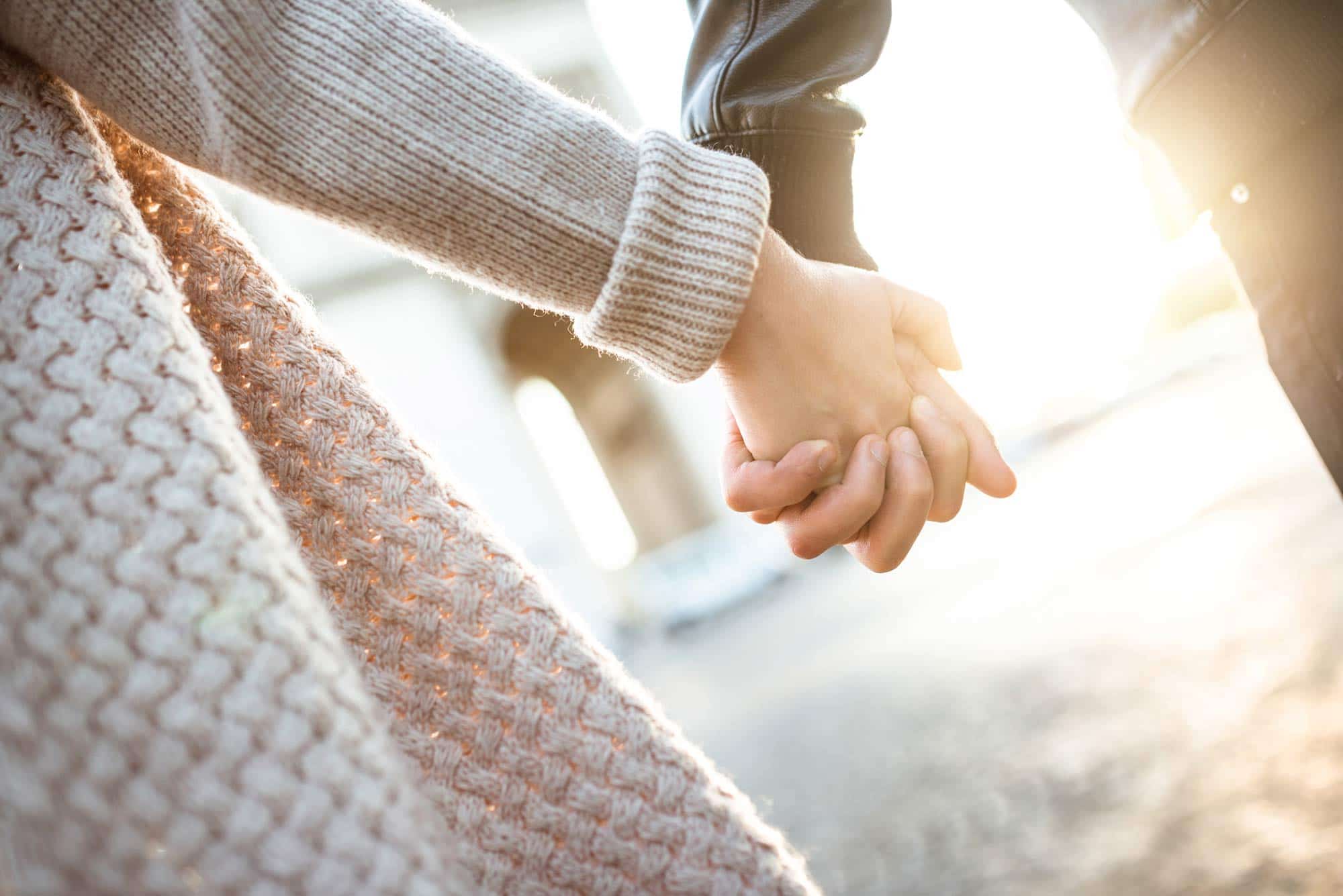 one couple holding hand close up